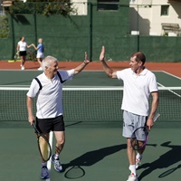 Tennis partners about to high-five on the court
